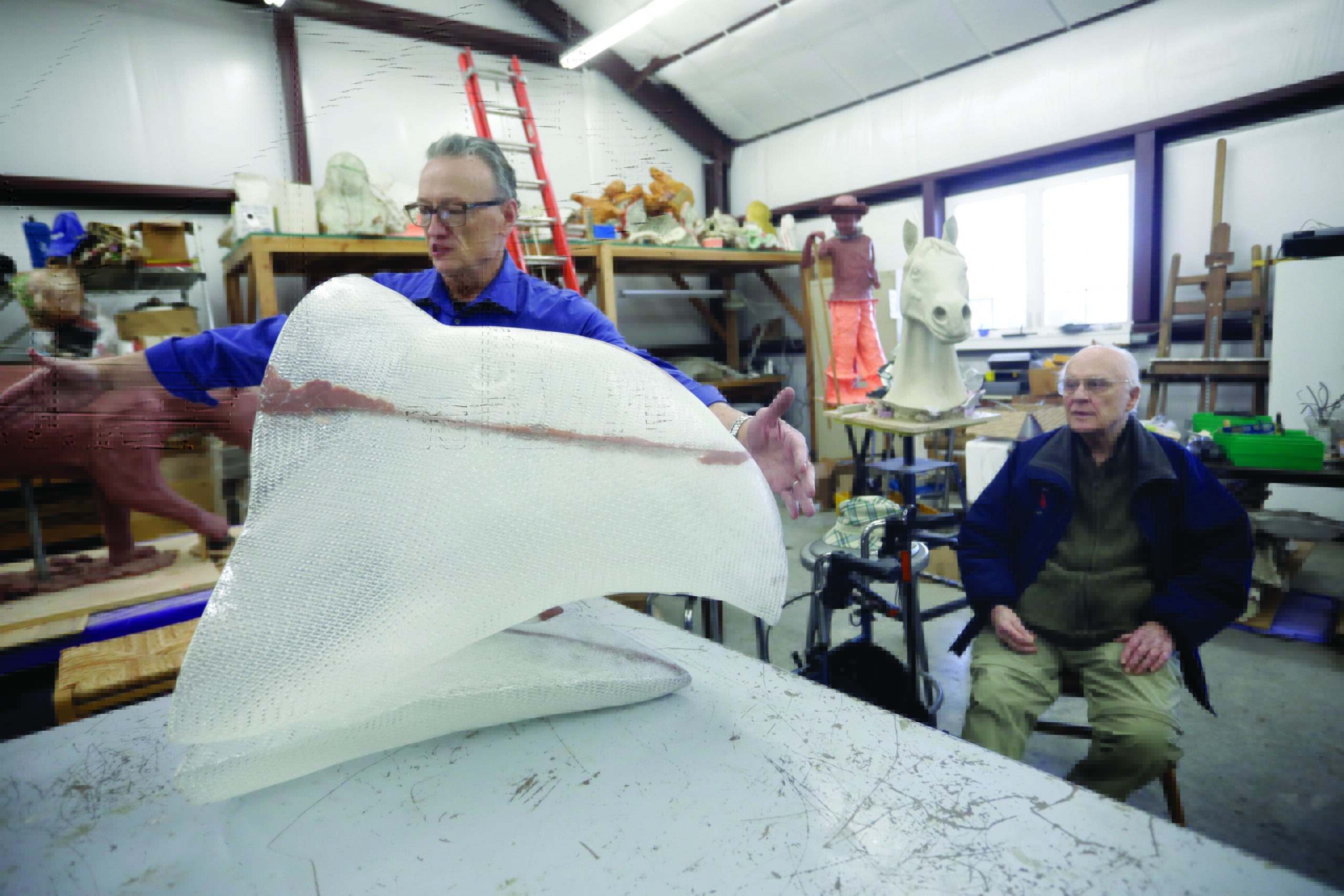 Artist Robin Richerson explains the ancient “Lost-Wax” Casting Method the design team employed to create the monuments. Due to the size of the monuments, each Jayhawk was cast in multiple pieces and then welded together. Here, the head and beak of the 1929 Jayhawk has been removed from its ceramic shell. 

Photo by Mike Yoder