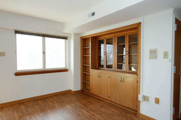 Two-bedroom unit — Living room with built-in cabinets.
