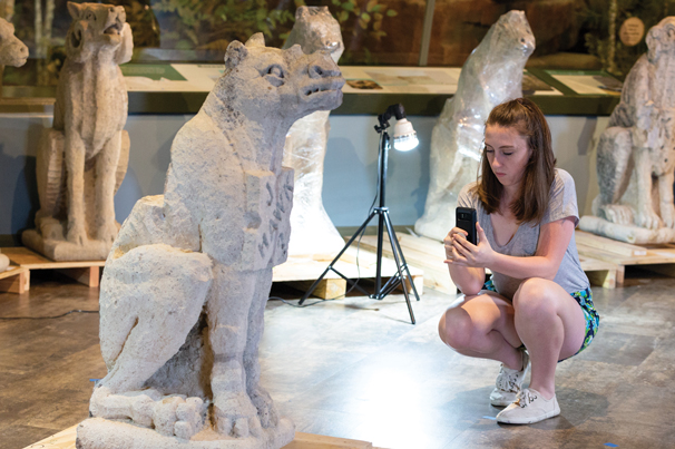 RESTORING HISTORY: Architecture student Elizabeth Overschmidt photographed the original rhino grotesque during the 3-D modeling phase of the project.Photo by University of Kansas/Whitney Young